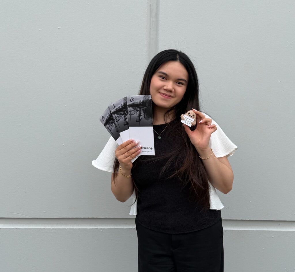 oi-marketing-marketing-coordinator-holding-brochures-and-cookie-photoshoot